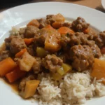 Plate Of Beef Stew With Rice And Vegetables